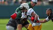 Gren Bay Packers running back MarShawn Lloyd (32) runs through a ball-security drill during training camp.