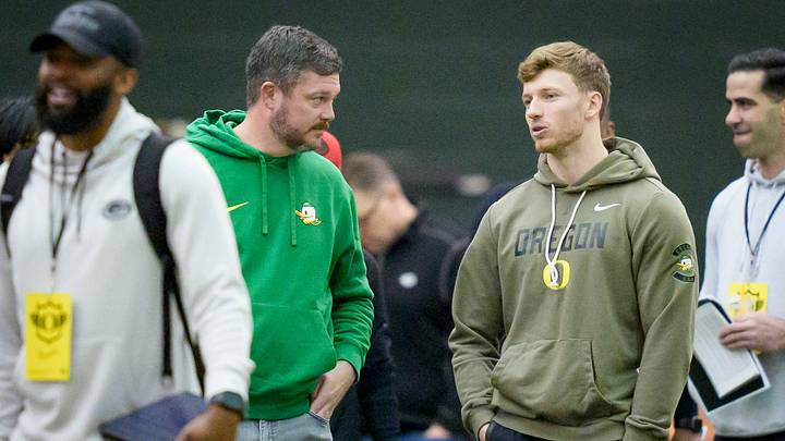 Oregon head coach Dan Lanning, left, talks to defensive back Dillon Thieneman during Oregon Pro Day on March 17, 2026, at the Moshofsky Center in Eugene, Oregon.