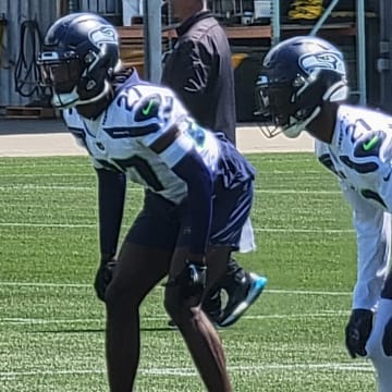 Devon Witherspoon and Riq Woolen prepare for the snap during a positional drill at Seahawks minicamp.