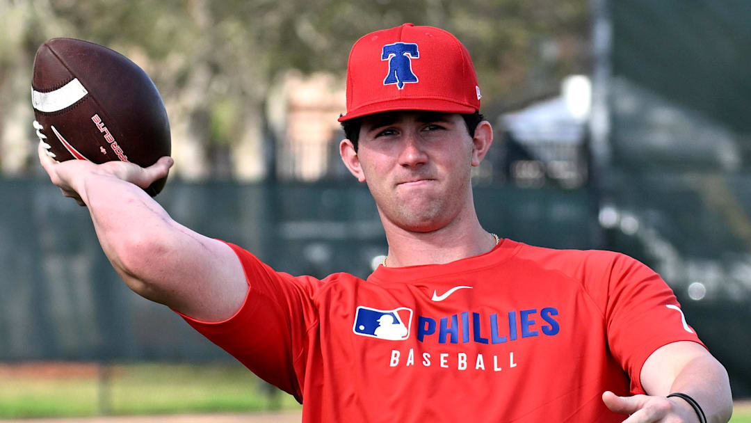 Feb 12, 2025; Clearwater, FL, USA; Philadelphia Phillies pitcher Andrew Painter (76) throws a football during a spring training workout at Carpenter Complex Feb 12, 2025; Clearwater, FL, USA; Philadelphia Phillies pitcher Andrew Painter (76) throws a football during a spring training workout at Carpenter Complex