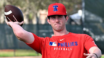 Feb 12, 2025; Clearwater, FL, USA; Philadelphia Phillies pitcher Andrew Painter (76) throws a football during a spring training workout at Carpenter Complex