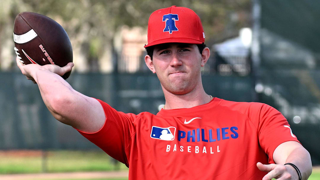Feb 12, 2025; Clearwater, FL, USA; Philadelphia Phillies pitcher Andrew Painter (76) throws a football during a spring training workout at Carpenter Complex 