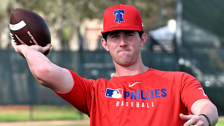 Feb 12, 2025; Clearwater, FL, USA; Philadelphia Phillies pitcher Andrew Painter (76) throws a football during a spring training workout at Carpenter Complex Feb 12, 2025; Clearwater, FL, USA; Philadelphia Phillies pitcher Andrew Painter (76) throws a football during a spring training workout at Carpenter Complex
