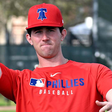 Feb 12, 2025; Clearwater, FL, USA; Philadelphia Phillies pitcher Andrew Painter (76) throws a football during a spring training workout at Carpenter Complex