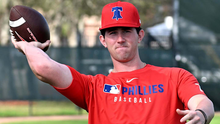 Feb 12, 2025; Clearwater, FL, USA; Philadelphia Phillies pitcher Andrew Painter (76) throws a football during a spring training workout at Carpenter Complex. Feb 12, 2025; Clearwater, FL, USA; Philadelphia Phillies pitcher Andrew Painter (76) throws a football during a spring training workout at Carpenter Complex.