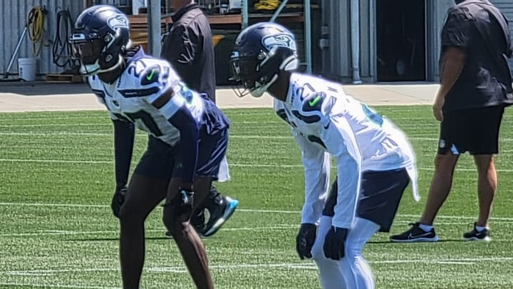 Devon Witherspoon and Riq Woolen prepare for the snap during a positional drill at Seahawks minicamp.