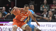 Feb 19, 2025; Tallahassee, Florida, USA; Miami Hurricanes guard Matthew Cleveland (0) fights for possession against Florida State Seminoles forward Jamir Watkins (1) during the first half at Donald L. Tucker Center. Mandatory Credit: Melina Myers-Imagn Images