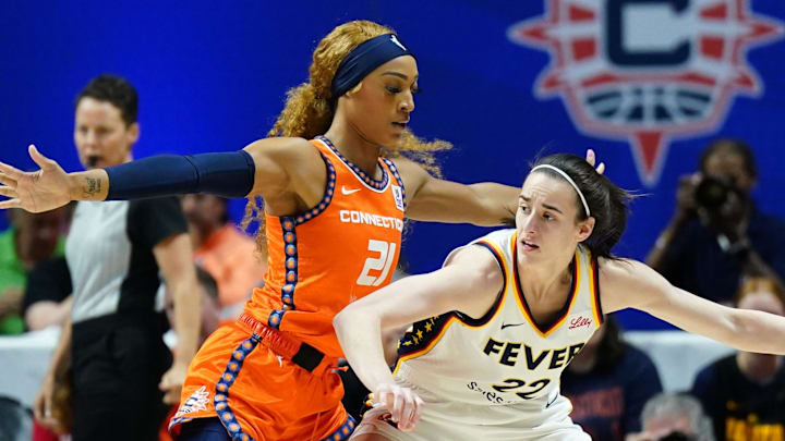 Jun 10, 2024; Uncasville, Connecticut, USA; Indiana Fever guard Caitlin Clark (22) moves the ball against Connecticut Sun guard DiJonai Carrington (21) in the first quarter at Mohegan Sun Arena. Mandatory Credit: David Butler II-Imagn Images
