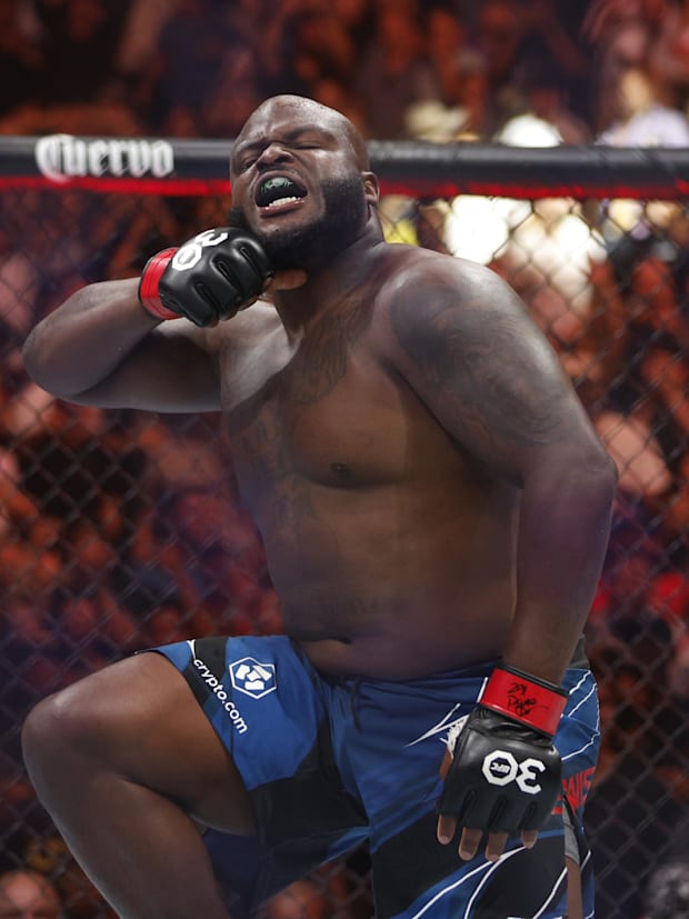 Derrick Lewis (red gloves) reacts to defeating Marcos Rogerio De Lima (blue gloves) during UFC 291 at Delta Center