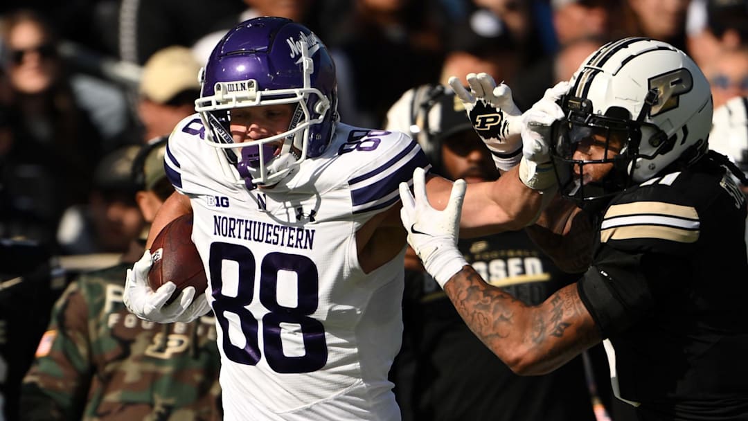 Nov 2, 2024; West Lafayette, Indiana, USA; Northwestern Wildcats tight end Marshall Lang (88) pushes away Purdue Boilermakers defensive back Antonio Stevens (11) during the second quarter at Ross-Ade Stadium.