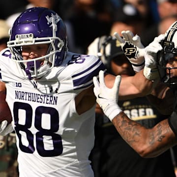 Nov 2, 2024; West Lafayette, Indiana, USA; Northwestern Wildcats tight end Marshall Lang (88) pushes away Purdue Boilermakers defensive back Antonio Stevens (11) during the second quarter at Ross-Ade Stadium.