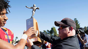 Lincoln football coach Phil Ferrigno (right) hands off one of the school's 10 San Francisco Section championship trophies from 2005 to 2023 with him as head coach. This was after 35-0 win over Balboa in the 2023 title game at Kezar Stadium.