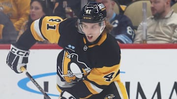 Apr 17, 2025; Pittsburgh, Pennsylvania, USA;  Pittsburgh Penguins right wing Ville Koivunen (41) moves the puck against the Washington Capitals during the second period at PPG Paints Arena. Mandatory Credit: Charles LeClaire-Imagn Images