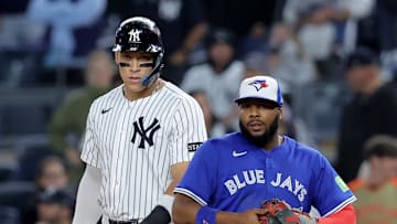 Oct 8, 2025; Bronx, New York, USA; New York Yankees right fielder Aaron Judge (99) leads off first base against Toronto Blue Jays first baseman Vladimir Guerrero Jr. (27) during the ninth inning of game four of the ALDS round of the 2025 MLB playoffs at Yankee Stadium. Mandatory Credit: Brad Penner-Imagn Images