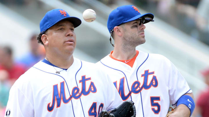 Mets starting pitcher Bartolo Colon (40) gets pulled from the game in the 5th inning against the San Francisco Giants as New York Mets third baseman David Wright (5) waits on the manager at Citi Field on Aug. 3, 2014.
