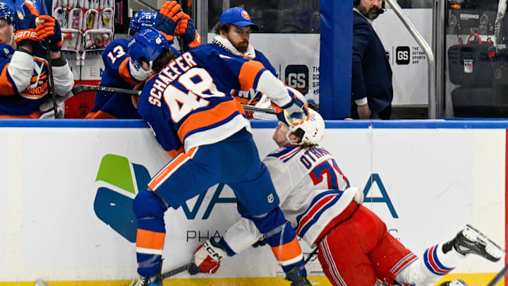 Jan 28, 2026; Elmont, New York, USA;  New York Islanders defenseman Matthew Schaefer (48) checks New York Rangers left wing Brennan Othmann (78) into the boards during the first period at UBS Arena. Mandatory Credit: Dennis Schneidler-Imagn Images