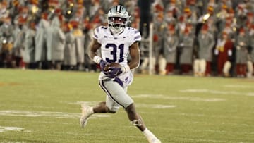 Nov 30, 2024; Ames, Iowa, USA; Kansas State Wildcats running back DJ Giddens (31) runs for a first down against the Iowa State Cyclones in the second quarter at at Jack Trice Stadium. Mandatory Credit: Reese Strickland-Imagn Images