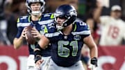 Sep 25, 2025; Glendale, Arizona, USA; Seattle Seahawks center Jalen Sundell (61) blocks for quarterback Sam Darnold (14) against the Arizona Cardinals at State Farm Stadium. Mandatory Credit: Mark J. Rebilas-Imagn Images