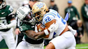 Michigan State's Jordan Hall, left, tackles UCLA's Anthony Frias II during the third quarter on Saturday, Oct. 11, 2025, at Spartan Stadium in East Lansing.