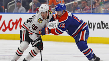 Nov 1, 2025; Edmonton, Alberta, CAN; Edmonton Oilers forward Adam Henrique (19) and Chicago Blackhawks forward Ryan Greene (20) battles for position during the second period at Rogers Place. Mandatory Credit: Perry Nelson-Imagn Images