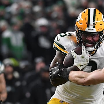 Green Bay Packers running back Josh Jacobs (8) rushes the ball against Philadelphia Eagles cornerback Cooper DeJean during last year's playoffs.