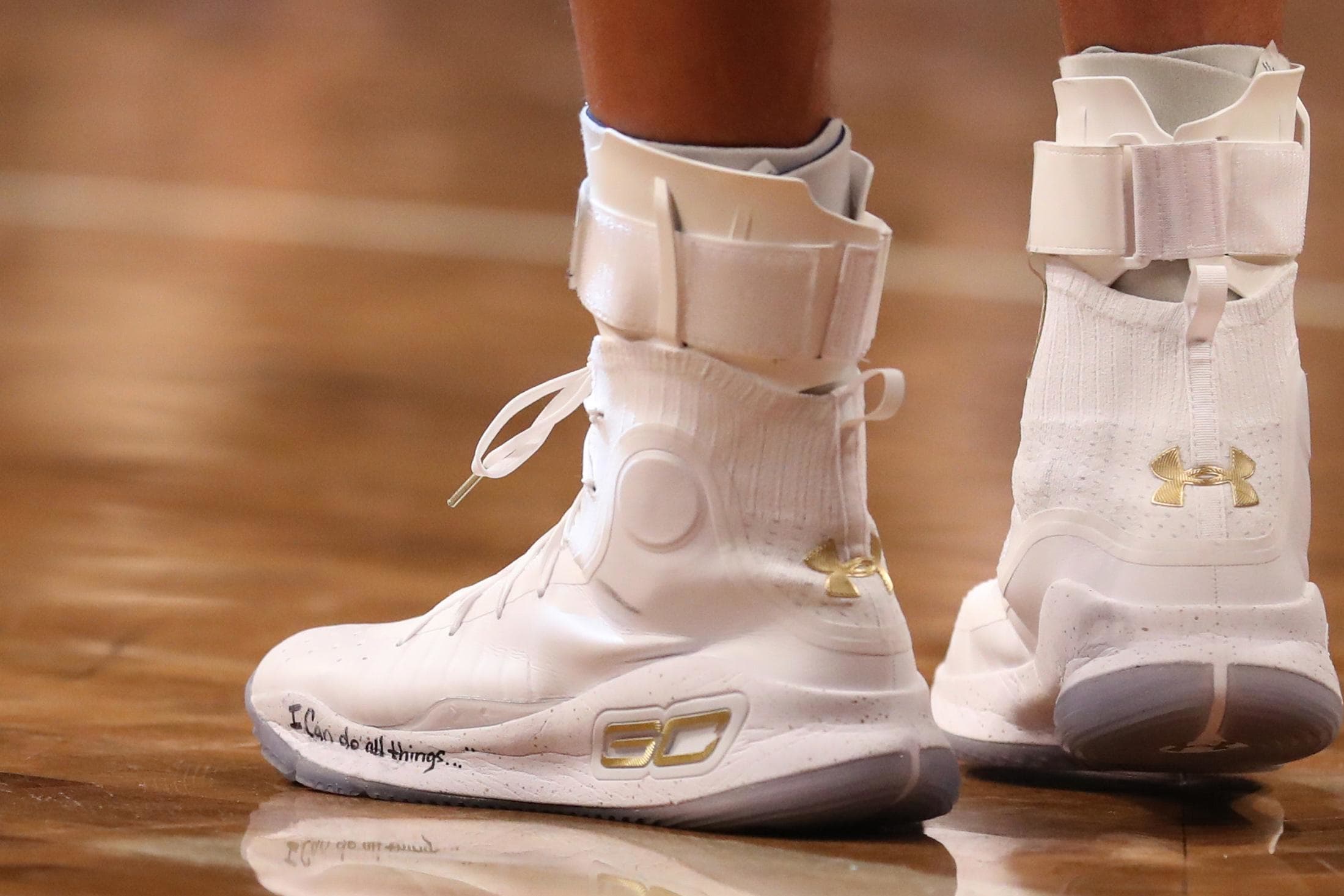 Stephen Curry's white and gold Under Armour shoes.