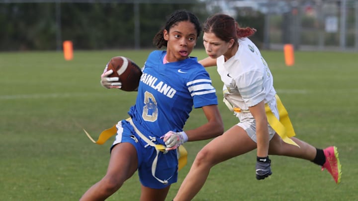 Mainland High's Kiera Williams #8 turns the corner and heads down field as Rine Ridge High's Colleen Champion #17 gives chase, Wednesday April 10, 2024 during flag football action at the Ormond Sports Complex.