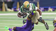 DeSoto's Myson Cook-Johnson is tripped up by Miller's Delson Cavaness at the Alamodome in 2024.