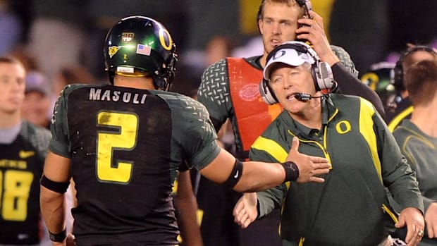 Dec 30, 2008; San Diego, CA, USA; Oregon Ducks coach Mike Bellotti congratulates quarterback Jeremiah Masoli (2) during the s