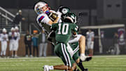 Madison Central's Christian Lawson (6) takes a hard hit from Trinity's Elijah Burns-Crump (10) and Myles Howze (4) as the Trinity Shamrocks and Madison Central Indians face off in the third round of the KHSAA Class 6A football playoffs. Trinity defeated Madison Central in a blowout, 64-27. Friday, Nov. 21, 2025.