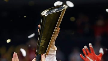 Ohio State Buckeyes head coach Urban Meyer holds up the National Championship trophy after beating Oregon Ducks 42-20 in College Football Playoff Championship game at AT&T Stadium in Arlington, Texas on January 12, 2015. (Dispatch photo by Kyle Robertson)