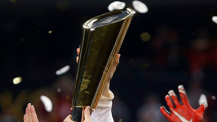 Ohio State Buckeyes head coach Urban Meyer holds up the National Championship trophy after beating Oregon Ducks 42-20 in College Football Playoff Championship game at AT&T Stadium in Arlington, Texas on January 12, 2015. (Dispatch photo by Kyle Robertson)