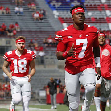 Ohio State Buckeyes quarterbacks, from left, Joe Burrow, Tate Martell and Dwayne Haskins warm up prior to the NCAA football game against the Army Black Knights at Ohio Stadium in Columbus on Sept. 16, 2017.