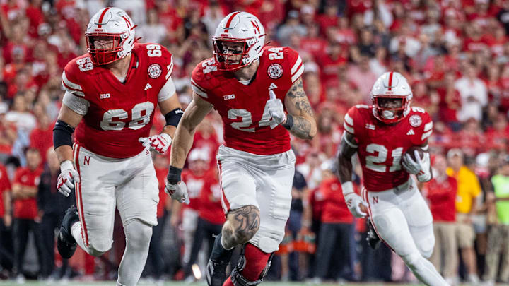 Nebraska offensive lineman Turner Corcoran and tight end Thomas Fidone II lead the way for running back Emmett Johnson against Colorado.