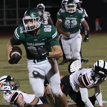 Flagler Palm Coast's Roman Caliendo (81) breaks free from a couple of Spruce Creek defenders during the Region 1-7A quarterfinals, Friday, Nov. 15, 2024.