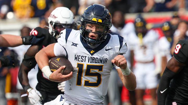 Nov 1, 2025; Houston, Texas, USA; West Virginia Mountaineers quarterback Scotty Fox Jr. (15) rushes for a touchdown against the Houston Cougars in the second half at TDECU Stadium. Mandatory Credit: Thomas Shea-Imagn Images