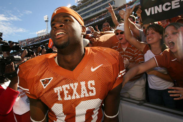 Vince Young celebrates with fans after Texas' win over Oklahoma in 2005.