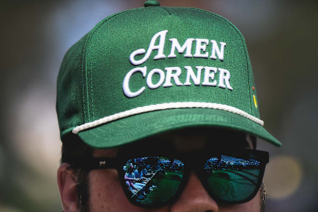 A close-up of a patron's hat that reads "Amen Corner" in bold letters.