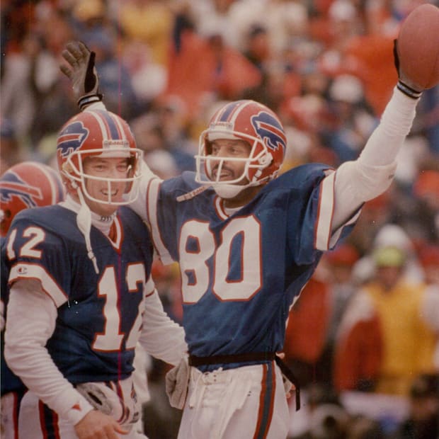 Jim Kelly congratulates James Lofton