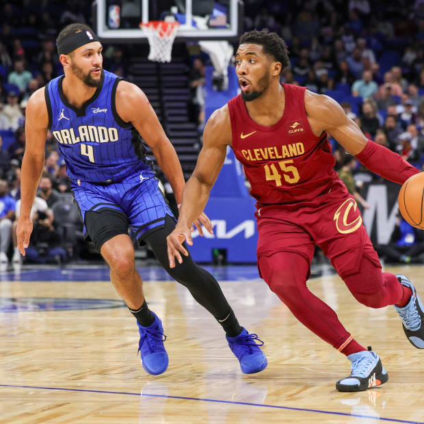 Dec 11, 2023; Orlando, Florida, USA; Cleveland Cavaliers guard Donovan Mitchell (45) drives around Orlando Magic guard Jalen Suggs (4) during the first quarter at Amway Center. Mandatory Credit: Mike Watters-USA TODAY Sports | Mike Watters-USA TODAY Sports