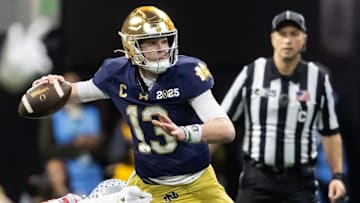 Notre Dame Fighting Irish quarterback Riley Leonard (13) against the Ohio State Buckeyes during the CFP National Championship college football game at Mercedes-Benz Stadium.