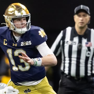 Notre Dame Fighting Irish quarterback Riley Leonard (13) against the Ohio State Buckeyes during the CFP National Championship college football game at Mercedes-Benz Stadium.