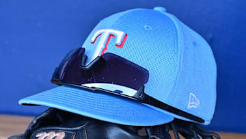 Mar 15, 2024; Salt River Pima-Maricopa, Arizona, USA; General view of a Texas Rangers hat, glove, and glasses prior to a spring training game against the Colorado Rockies at Salt River Fields at Talking Stick. 