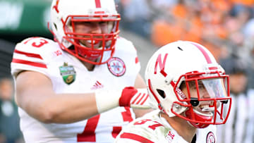 Nebraska football receiver Brandon Reilly (87) celebrates with offensive lineman Sam Hahn (73) after a touchdown