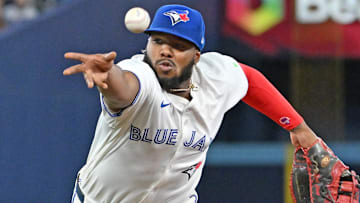 Apr 19, 2025; Toronto, Ontario, CAN;  Toronto Blue Jays first baseman Vladimir Guerrero Jr. (27) misplays a throw to first base attempting to put out Seattle Mariners shortstop J.P. Crawford (not shown) in the ninth inning at Rogers Centre.