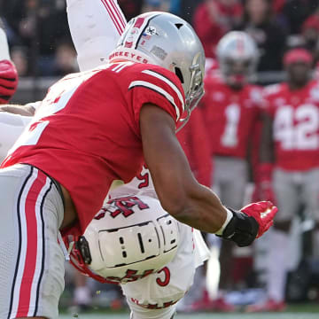 Utah Utes running back TJ Pledger (5) is flipped upside down by Ohio State Buckeyes safety Kourt Williams II (2) during the first quarter of the Rose Bowl in Pasadena, Calif. on Jan. 1, 2022.

College Football Rose Bowl