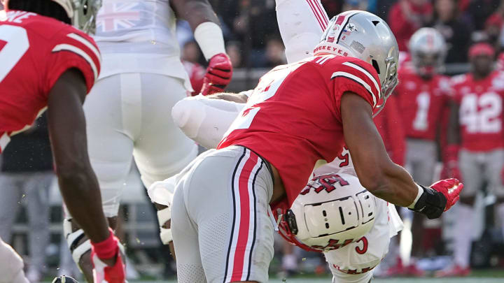 Utah Utes running back TJ Pledger (5) is flipped upside down by Ohio State Buckeyes safety Kourt Williams II (2) during the first quarter of the Rose Bowl in Pasadena, Calif. on Jan. 1, 2022.

College Football Rose Bowl