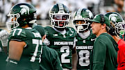 Michigan State's Aidan Chiles, left, and quarterbacks coach Jon Boyer meet on the sideline during the fourth quarter in the game against Youngstown State on Saturday, Sept. 13, 2025, at Spartan Stadium in East Lansing.
