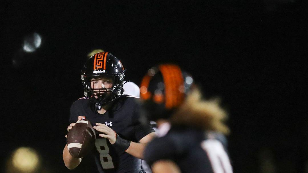 Lely Trojans quarterback Brady Quinn (8) looks to pass to receiver Ty Collins (0) during the second quarter of a Week 5 game against the Sarasota Booker Tornadoes at Lely High School in Naples, Fla., on Friday, Sept. 19, 2025.