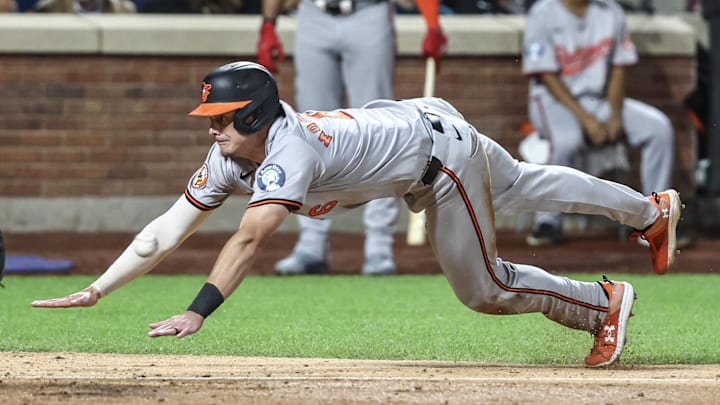 Aug 20, 2024; New York City, New York, USA;  Baltimore Orioles first baseman Ryan Mountcastle (6) slides into home plate in the ninth inning against the New York Mets at Citi Field. Mandatory Credit: Wendell Cruz-Imagn Images